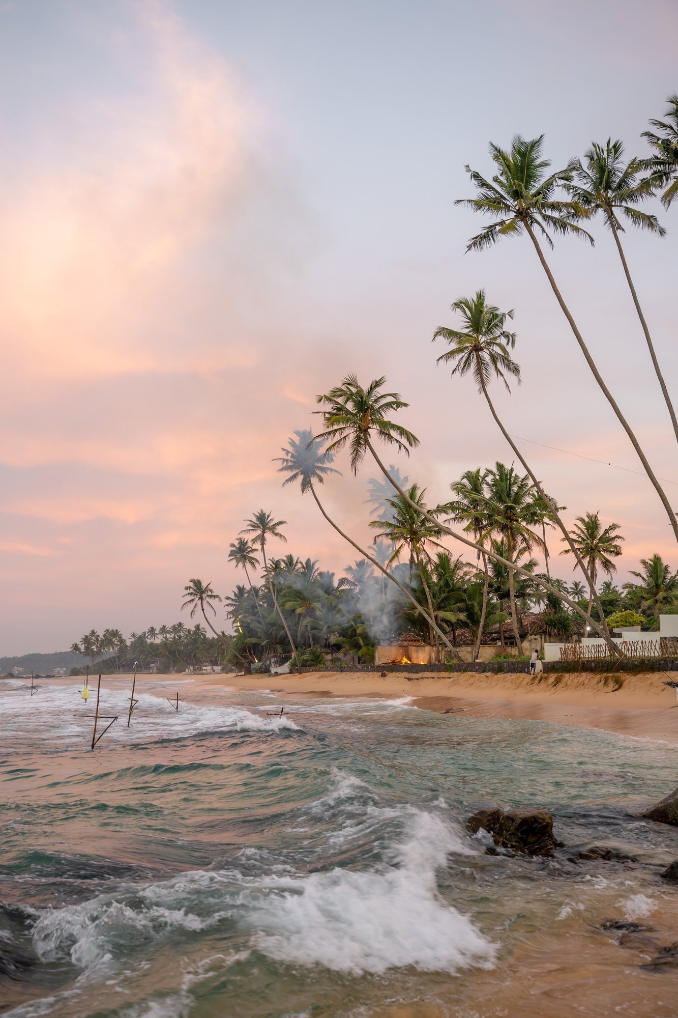 Sunrise with fishermen in Unawatuna, Sri Lanka, beach, palm trees and ocean
