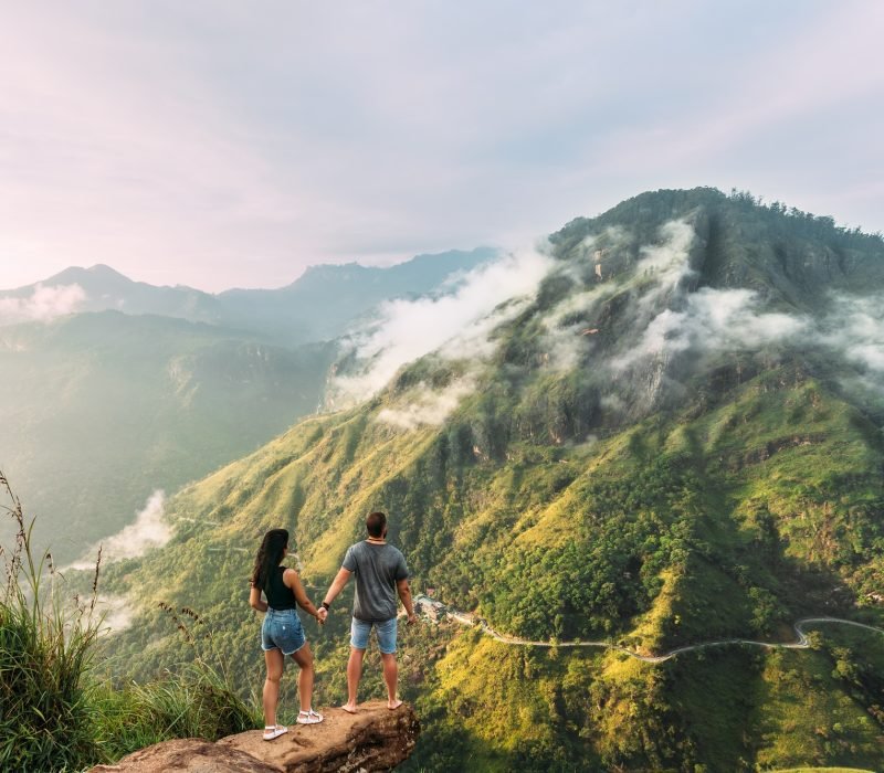 The couple greets the sunrise in the mountains. Boy and girl in the mountains